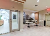 Thumbnail 17 of 21 - resident lounge with social seating and tables at archer park apartments in southeast Washington dc