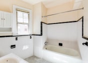 Thumbnail 12 of 29 - bathroom with tub, medicine cabinet and window at the frontenac apartments in van ness washington dc
