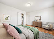 Thumbnail 7 of 23 - A bedroom with a bed, a dresser, a mirror, and a chair.