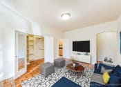 Thumbnail 2 of 20 - living area with hardwood flooring, social seating, coffee table and tv at baystate apartments in washington dc