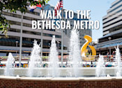 Thumbnail 17 of 17 - A fountain in front of a building with the text "Walk to the Bethesda Metro" overlaid on the image.