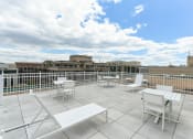 Thumbnail 6 of 47 - rooftop lounge with lounge chairs, social seating and tables at brunswick house apartments in dupont circle washington dc