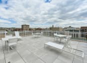 Thumbnail 5 of 47 - rooftop lounge with lounge chairs, social seating and tables at brunswick house apartments in dupont circle washington dc