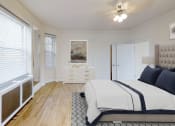 Thumbnail 8 of 25 - bedroom with bed, dresser, night stands, tv, ceiling fan and large windows at the calvertion apartments in washington dc