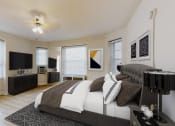 Thumbnail 7 of 25 - bedroom with bed, dresser, night stands, tv, ceiling fan and large windows at the calvertion apartments in washington dc