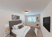 Thumbnail 8 of 23 - bedroom with bed, nightstands, large windows and tv at cambridge square apartments in bethesda md