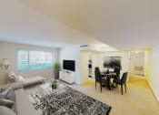 Thumbnail 7 of 23 - living area with sofa, coffee table, large windows, and views of kitchen and dining areas at cambridge square apartments in bethesda md