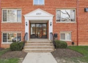 Thumbnail 1 of 23 - exterior entrance of brick apartments at cambridge square apartments in bethesda md
