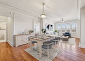 Thumbnail 1 of 32 - A dining room with a table set for four.