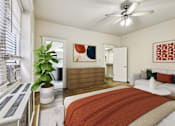Thumbnail 12 of 32 - A bedroom with a bed, a plant, and a painting on the wall.