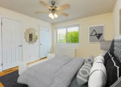 Thumbnail 16 of 24 - a bedroom with a bed, 2 closets, ceiling fan and window at chillum place apartments in washington dc