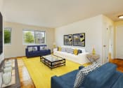 Thumbnail 7 of 24 - living area with large windows, sofa, love seat and coffee table at chillum place apartments in washington dc