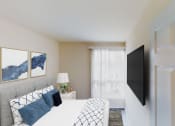 Thumbnail 4 of 7 - bedroom with bed, night stands, large windows and tv at city towns apartments in washington dc