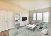 Thumbnail 6 of 18 - living area with sofa, coffee table, large windows, credenza, tv and view of bedroom at city view apartments in washington dc