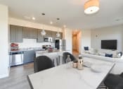 Thumbnail 4 of 18 - kitchen with stainless steel appliances, large breakfast bar and view of dining and living areas at city view apartments in washington dc