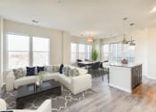 Thumbnail 5 of 18 - living area with sofa, coffee table , large windows, view of kitchen and view of dining area at city view apartments in washington dc