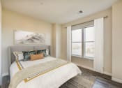 Thumbnail 8 of 18 - bedroom with bed, hardwood floors and large windows at city view apartments in washington dc