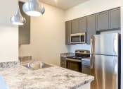 Thumbnail 3 of 18 - kitchen with stainless steel appliances and large breakfast bar at city view apartments in washington dc