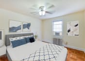 Thumbnail 8 of 21 - bedroom with bed, nightstands, ceiling fan, large closet and hardwood flooring at colonnade apartments in washington dc