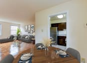 Thumbnail 3 of 21 - dining area with table, chairs, view of kitchen and living area at colonnade apartments in washington dc