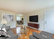 Thumbnail 5 of 21 - living area with sofa, coffee table, large windows, and view of dining areas at colonnade apartments in washington dc