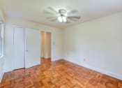 Thumbnail 10 of 21 - vacant bedroom with hardwood flooring and ceiling fan at colonnade apartments in washington dc