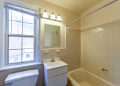 Thumbnail 21 of 21 - bathroom with vanity, mirror, tub, toilet and window at colonnade apartments in washington dc