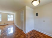 Thumbnail 19 of 21 - vacant dining area with view of living area with hardwood floors and large windows atcolonnade apartments in washington dc
