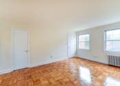 Thumbnail 17 of 21 - vacant living area with hardwood flooring and large windows at colonnade apartments in washington dc
