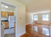 Thumbnail 15 of 21 - vacant living area with hardwood flooring, large windows and view of kitchen at colonnade apartments in washington dc