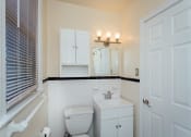 Thumbnail 8 of 12 - bathroom with toilet, vanity, medicine cabinet, mirror and large window at 2801 Pennsylvania apartments in washington dc