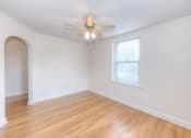 Thumbnail 4 of 21 - vacant living area with hardwood floors, large windows and ceiling fan at 6100 14th Street apartments in washington dc