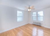 Thumbnail 8 of 21 - vacant living area with hardwood flooring, ceiling fan, and large windows at 6100 14th Street apartments in washington dc