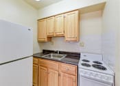 Thumbnail 2 of 16 - kitchen with gas range, wood cabinetry and energy efficient appliances at alpha house apartments in washington dc