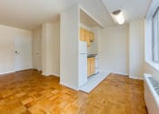 Thumbnail 15 of 47 - vacant living area with hardwood flooring, view of front entrance and kitchen at brunswick house apartments in dupont circle washington dc