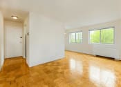 Thumbnail 17 of 24 - vacant living area with large windows, hardwood flooring and view of front entrance at chillum place apartments in lamond riggs washington dc