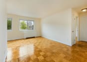 Thumbnail 18 of 24 - vacant living area with hardwood flooring and large windows at chillum place apartments in lamond riggs washington dc