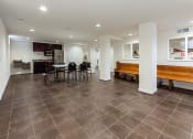 Thumbnail 17 of 25 - community room with social seating, tables and small kitchen at fairway park apartments in washington dc
