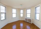 Thumbnail 16 of 22 - vacant living area with large windows and hardwood floors at the foreland apartments in capitol hill washington dc