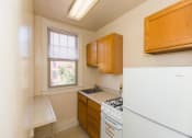 Thumbnail 2 of 22 - kitchen with refrigerator, gas range, breakfast bar and window at the foreland apartments in capitol hill washington dc