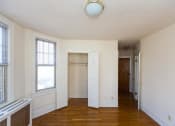 Thumbnail 17 of 22 - vacant living area with hardwood floors and coat closet at the foreland apartments in capitol hill washington dc