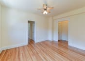 Thumbnail 20 of 28 - vacant bedroom with hardwood flooring and ceiling fan at the klingle apartments in washignton dc