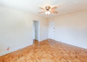 Thumbnail 13 of 33 - vacant bedroom with hardwood floors, closet and ceiling fan at the meridian park apartments in columbia heights washington dc