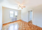 Thumbnail 16 of 33 - vacant living area with hardwood floors, ceiling fan and window at the meridian park apartments in columbia heights washington dc