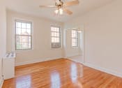 Thumbnail 16 of 29 - vacant living area with hardwood flooring, ceiling fan, and large windows at parkside apartments in washington dc