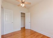 Thumbnail 18 of 29 - vacant bedroom with hardwood floors and ceiling fan at parkside apartments in washington dc