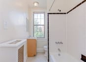 Thumbnail 20 of 29 - bathroom with tub, vanity, toilet and window at parkside apartments in washington dc