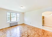 Thumbnail 7 of 17 - vacant living area with large windows, hardwood floors and view of kitchen and dining areas at randle circle apartments in washington dc
