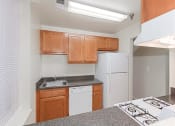 Thumbnail 4 of 17 - kitchen with refrigerator, dishwasher, gas range and wood cabinetry at the whitelaw apartments in washington dc