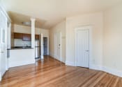 Thumbnail 18 of 35 - vacant living area with hardwood floors and view of breakfast bar in kitchen at dupont apartments in washington dc
